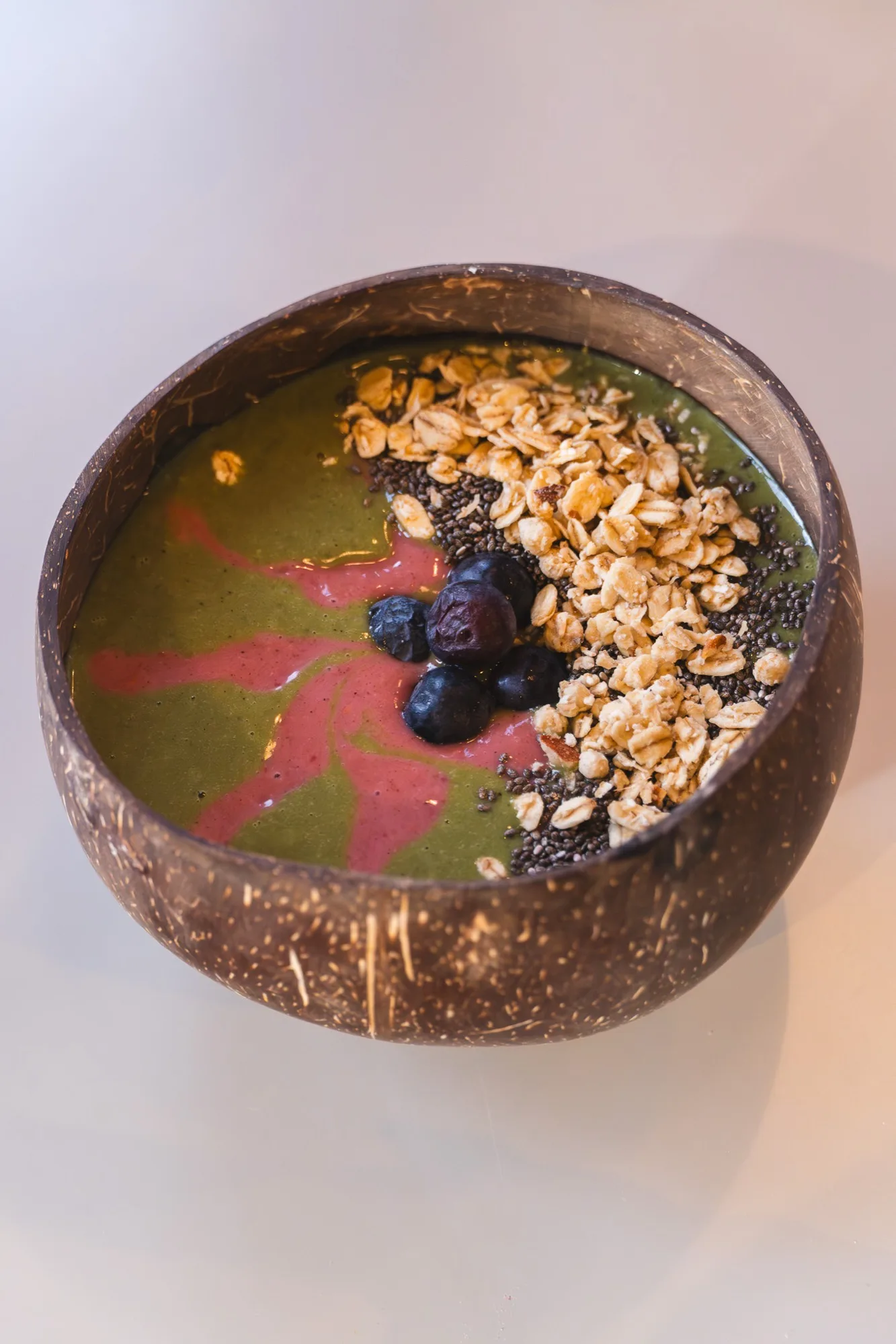 Green smoothie bowl with granola and blueberries